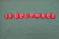 31 December,ÃÂ calendar date composed with multi colored stones over green sand